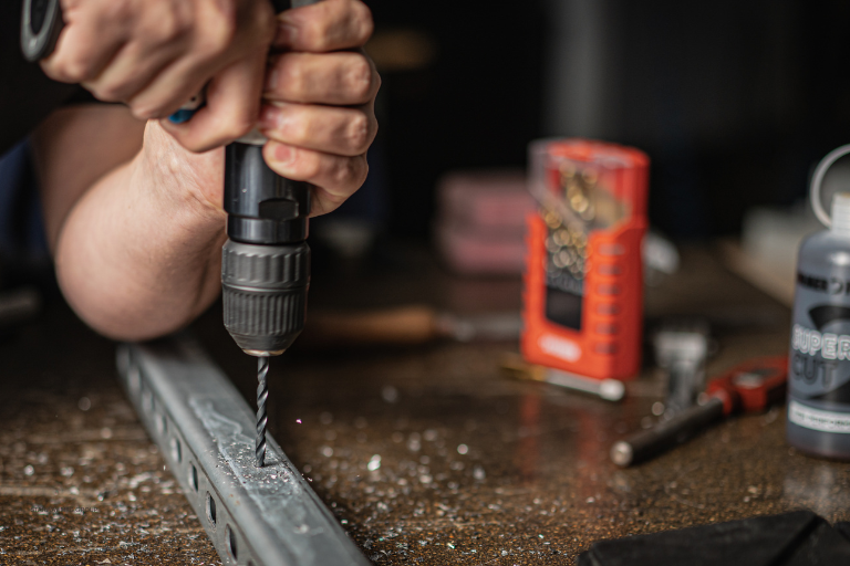 Drilling a mounting hole in a metal part