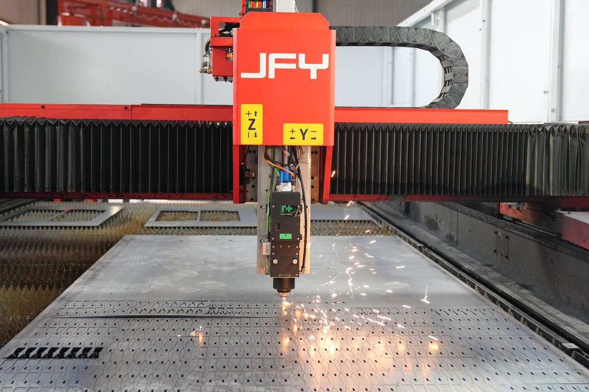 Fiber laser cutting nested parts from a steel sheet at STARWAY MFG GROUP