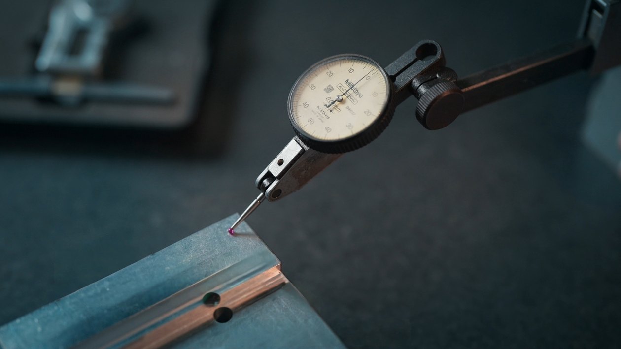 Dial test indicator checking a dimension on a machined metal part at STARWAY MFG GROUP